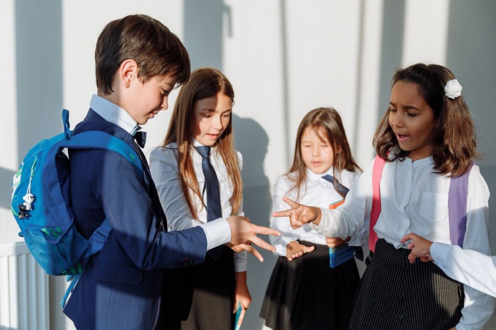 Children playing rock paper and scissors