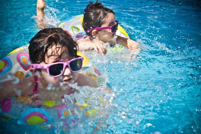 Kids Swimming during Daytime