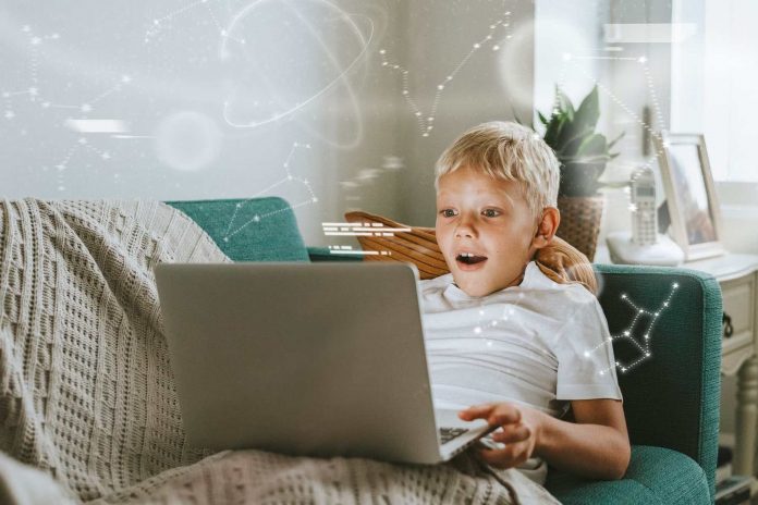 Child using a laptop with fascination