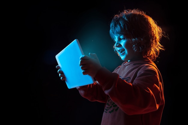 Little boy holding a tablet