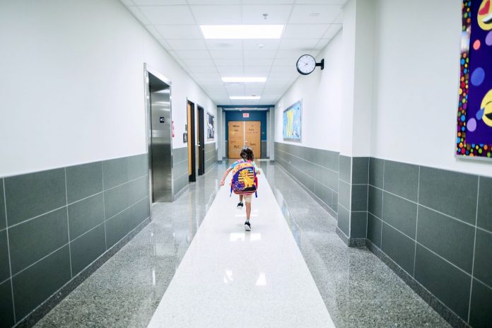 Kid running in school hallway