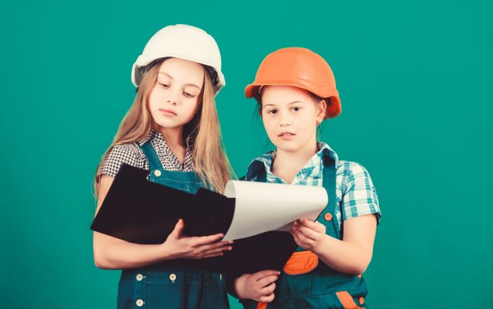 Two girls in construction helmet