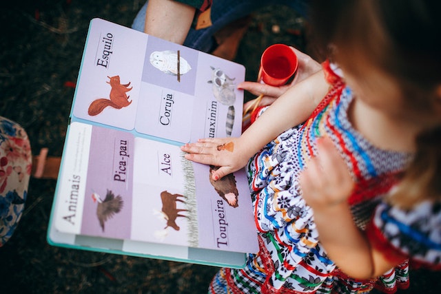 Child learning English in a garden