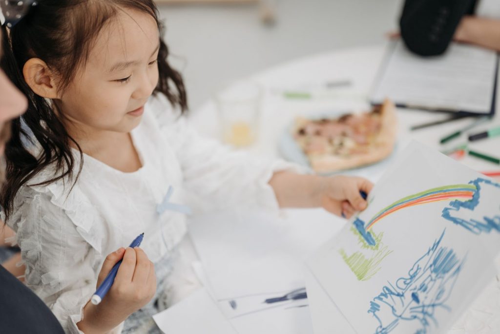 Close Up Shot of a Girl Using Color Pens