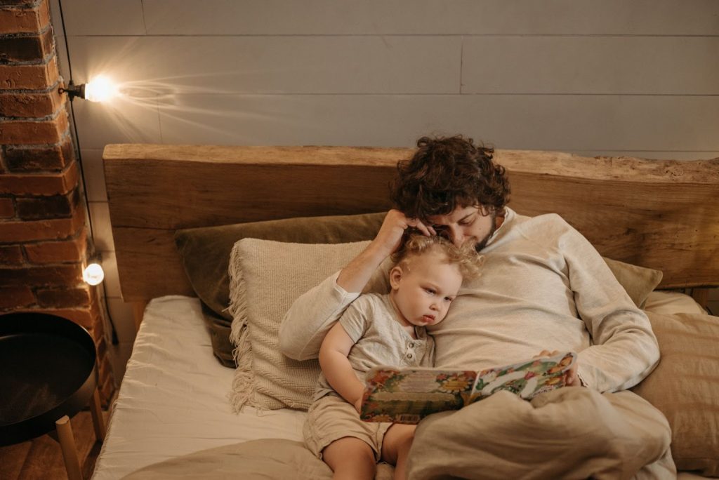 Father reading bedtime story to kid