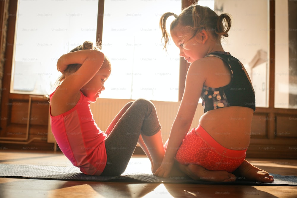 2 little girls exercising together