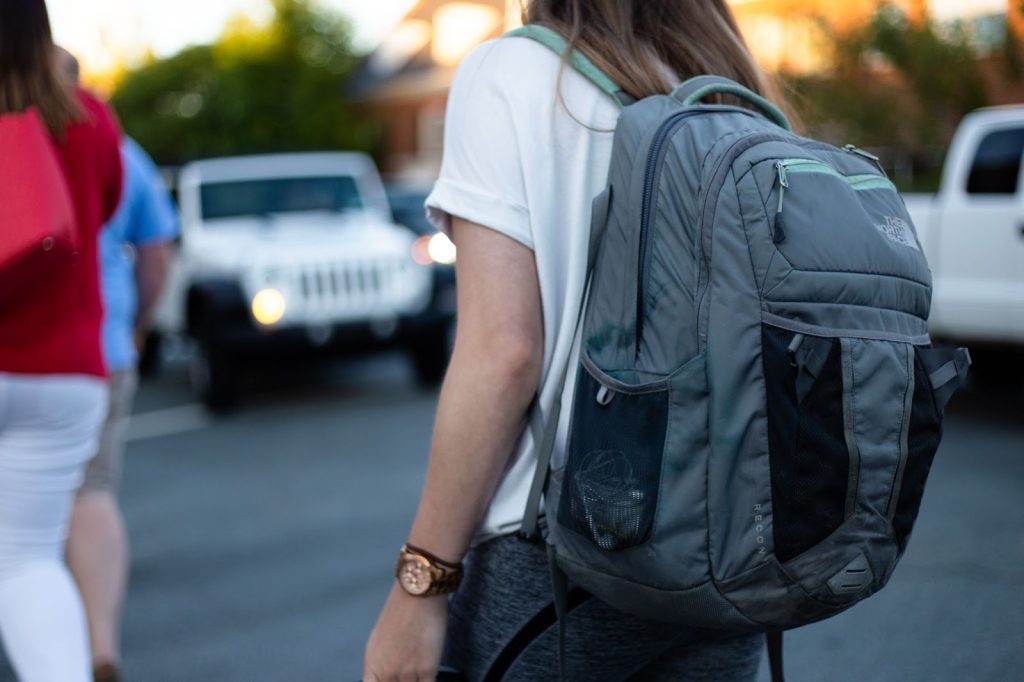 Girl wearing gray backpack