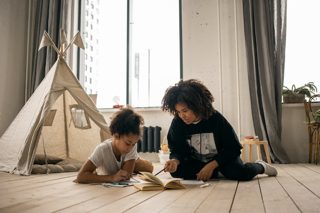 Parent teaching child about homeschooling