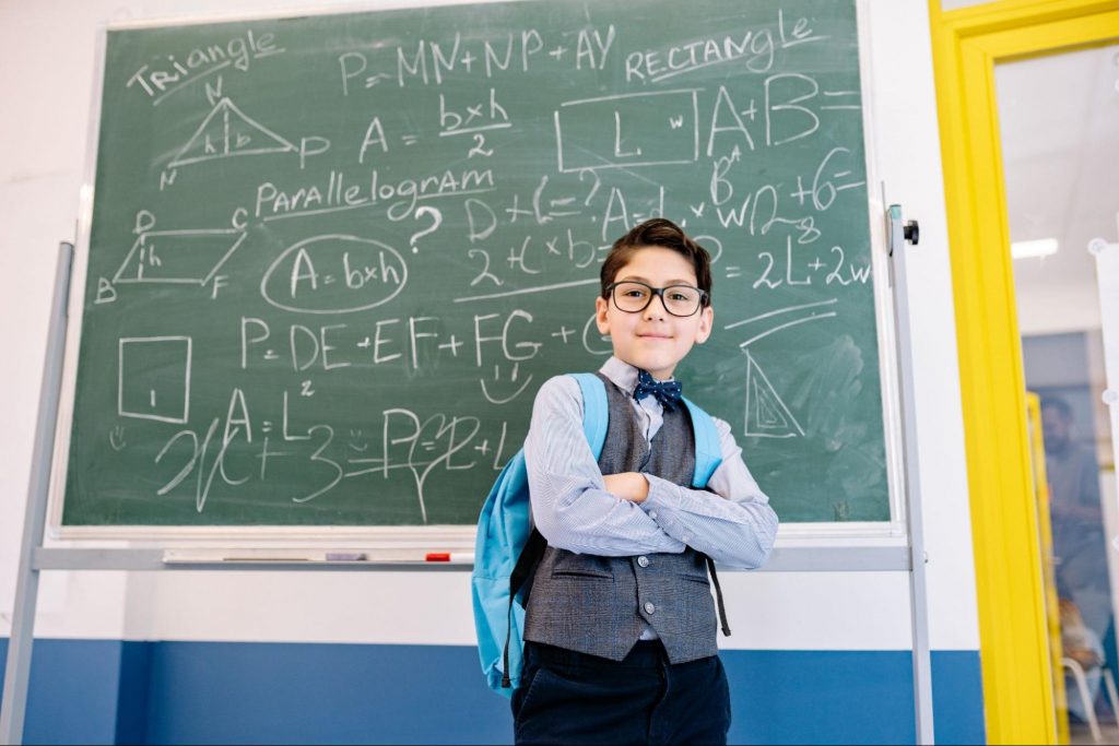 A student standing beside a chalkboard