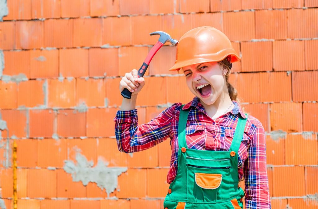 Girl with a hammer in hand