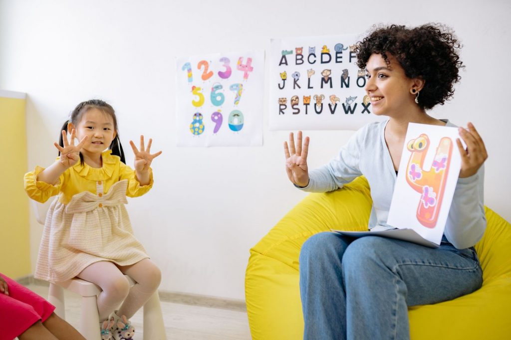 Teacher and kid counting on fingers