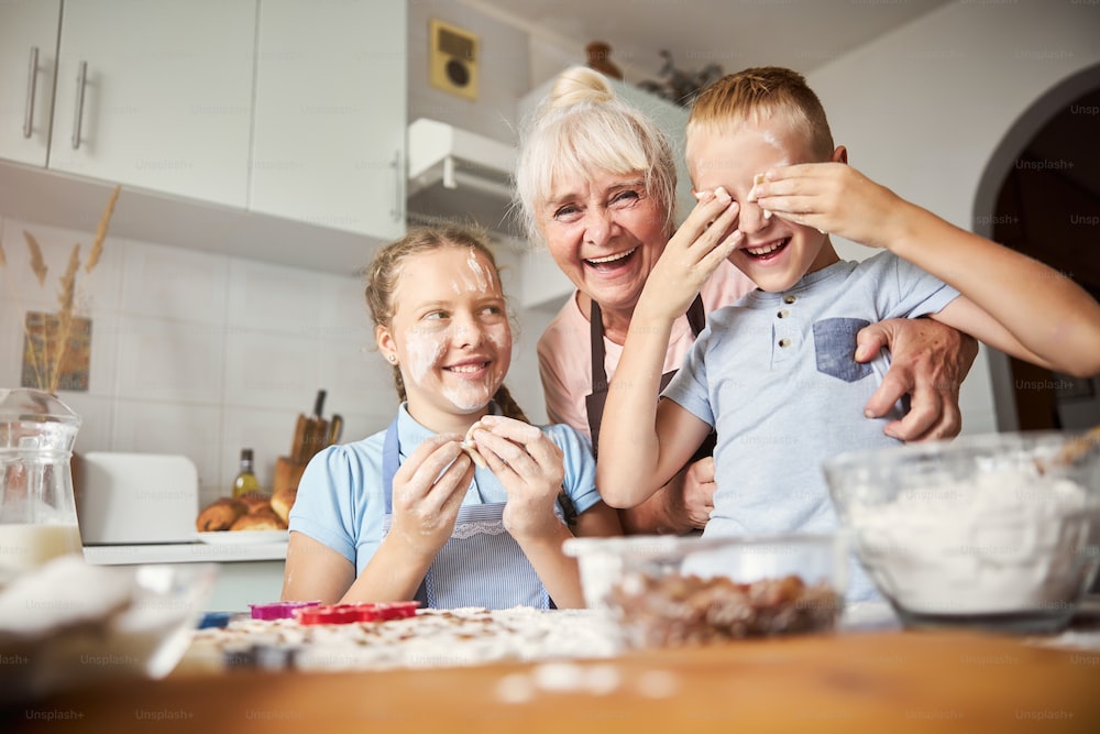 Kids baking with their grandmother