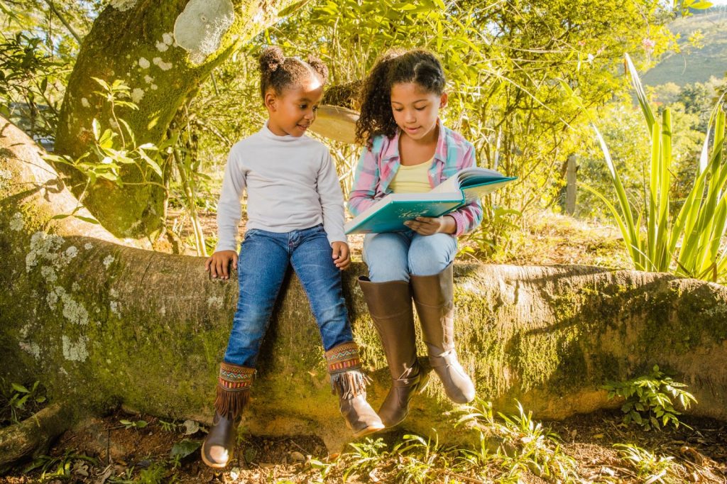 Two kids looking at a book