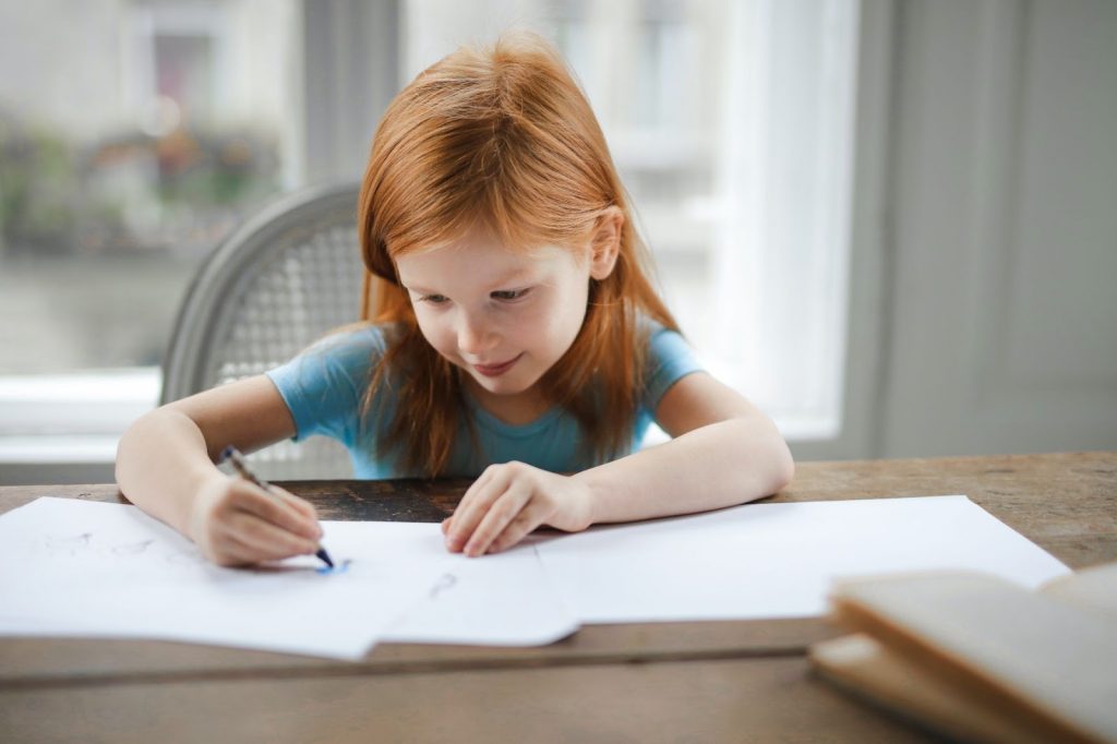 Girl drawing on paper