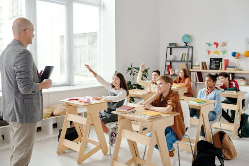 Teacher explaining lesson to children