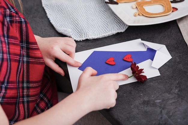 Kid making a handmade greeting card