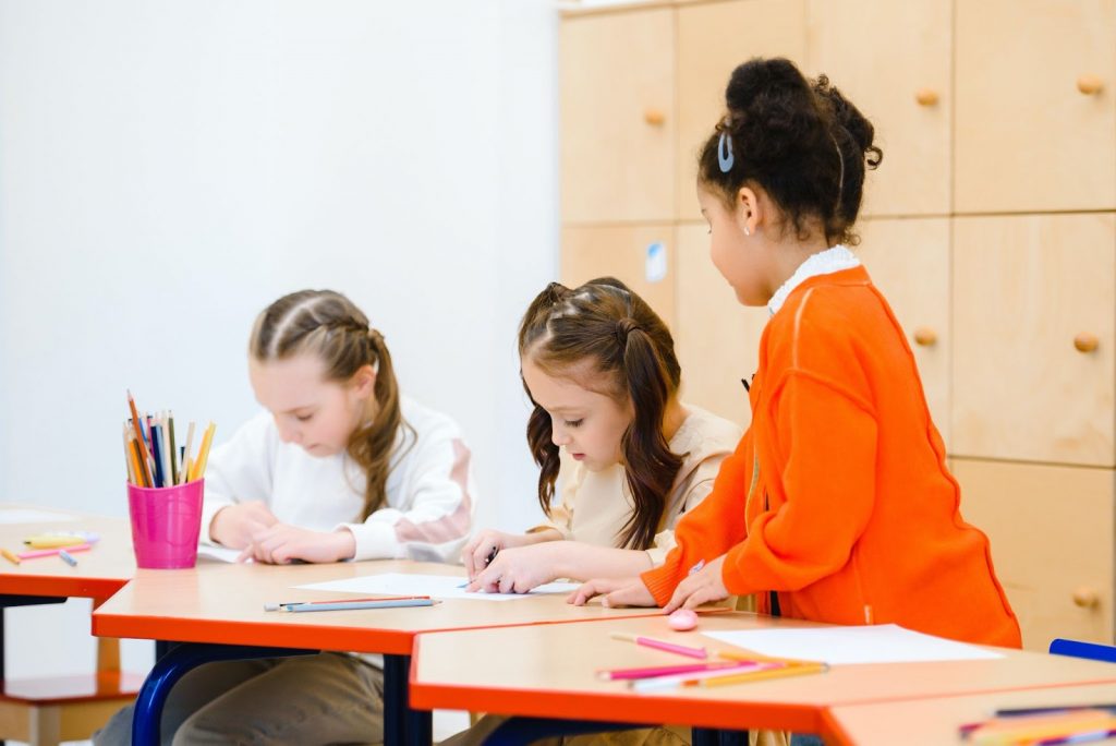 Young Girls Doing an Activity Inside the Classroom