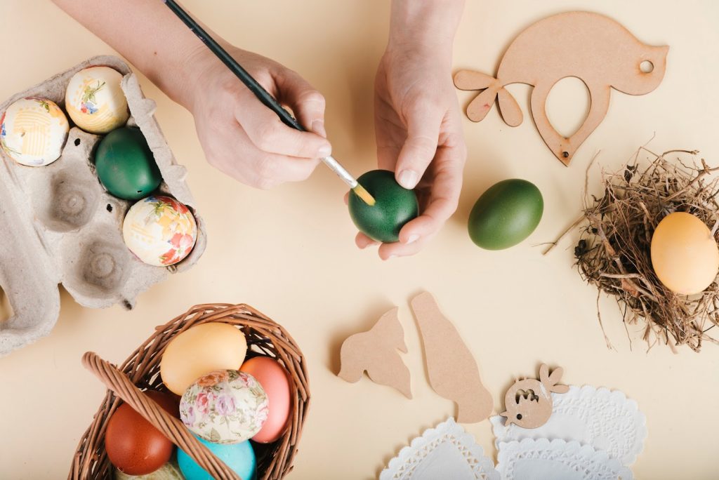 A person painting an egg