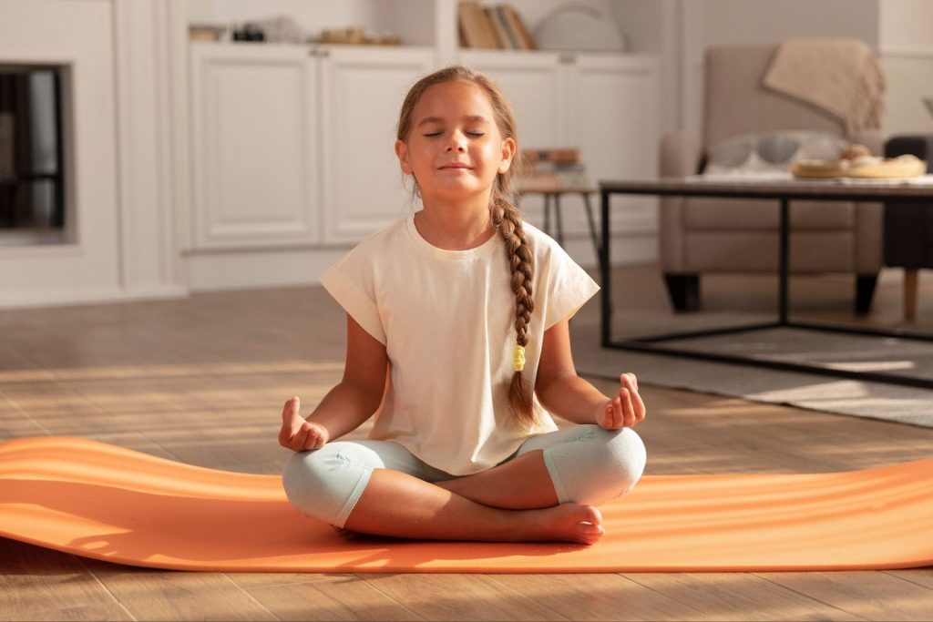 Little girl meditating indoors