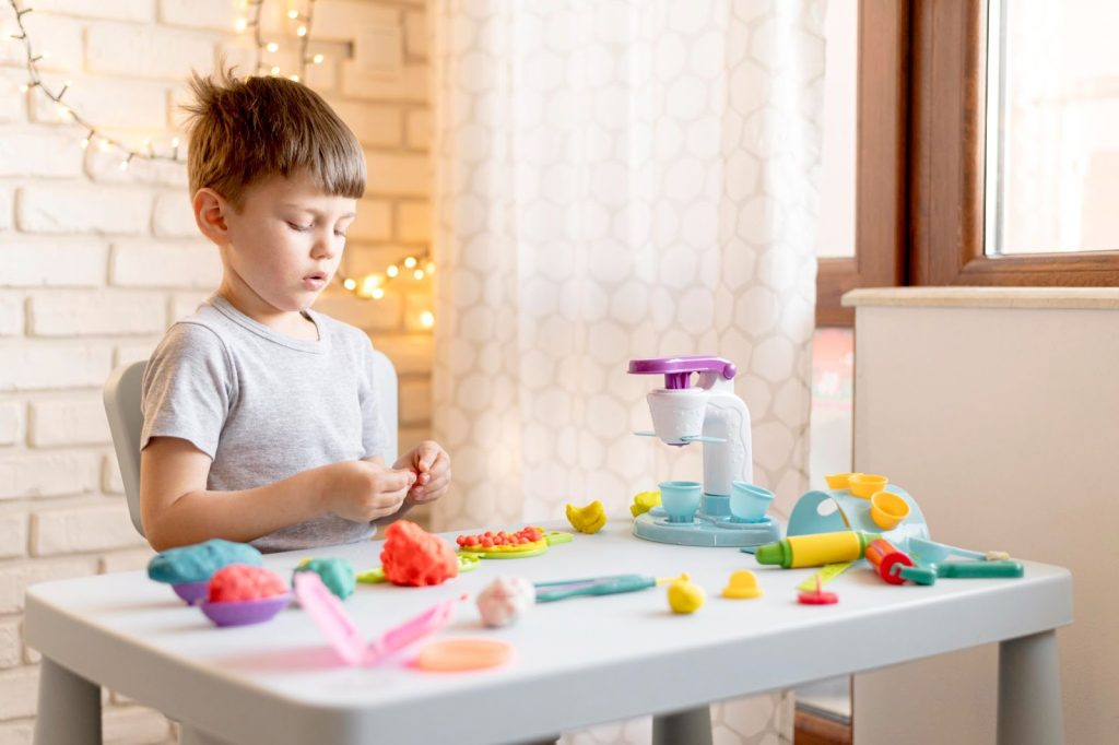 Kid playing with play dough