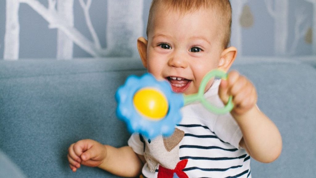 A child playing with a plastic rattle