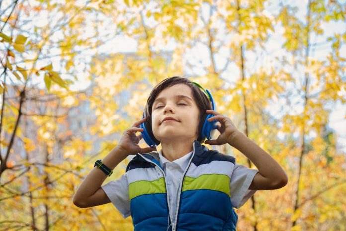Little boy listening to music on headphones