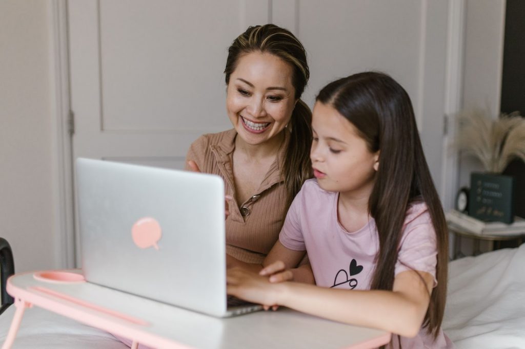 A Mother and Daughter Using a Laptop