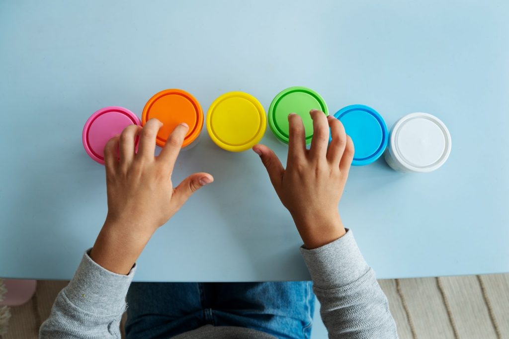 A person sorting colorful containers