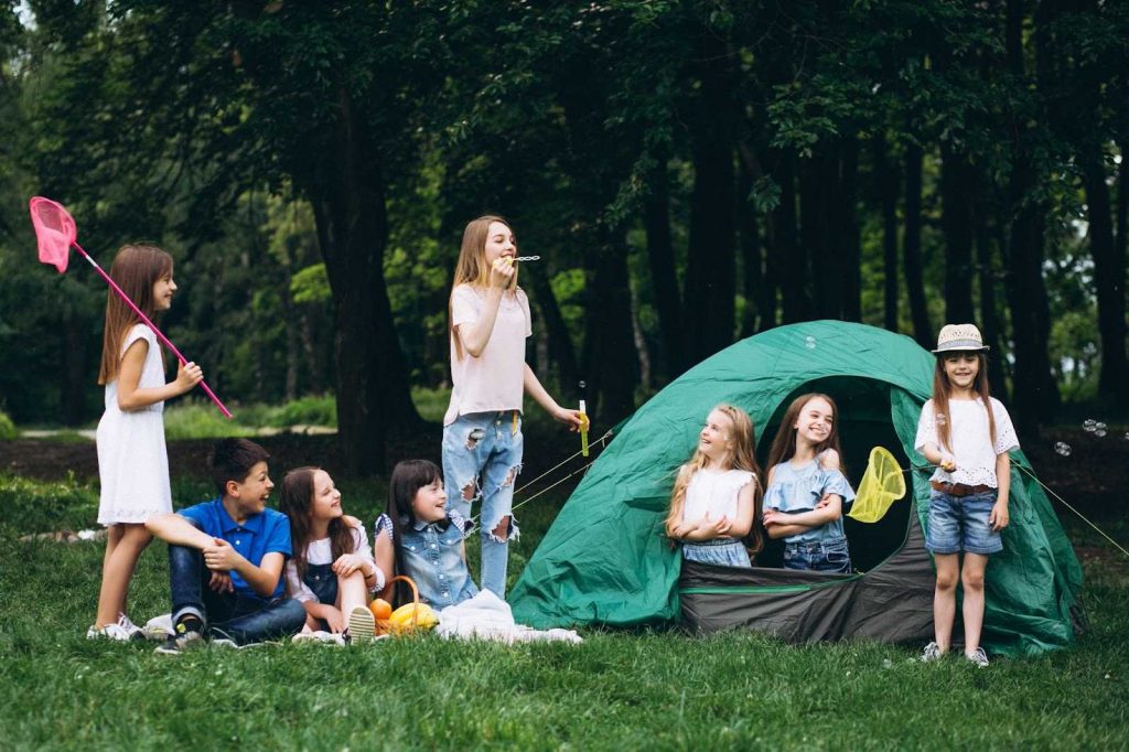 A bunch of kids in a forest camp