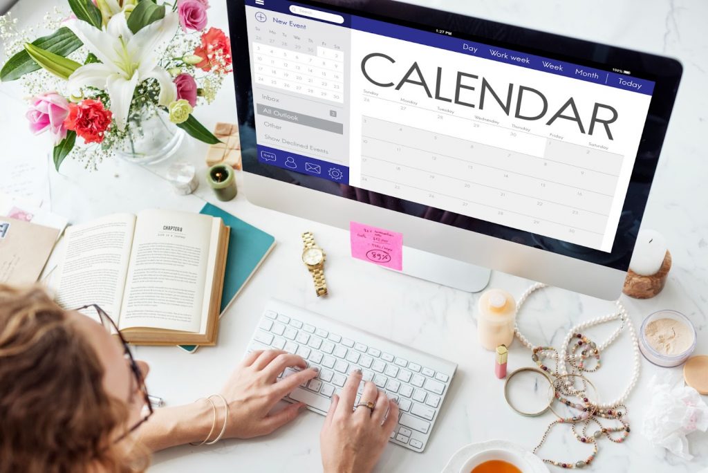 A woman creating a calendar on laptop