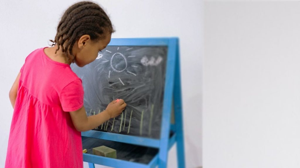 A girl drawing on a blackboard