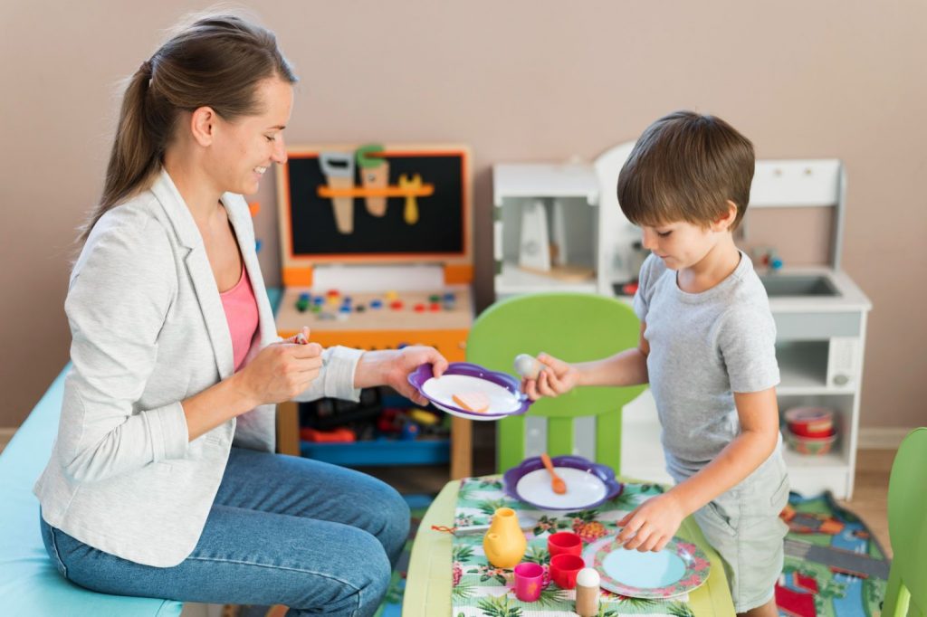 Teacher teaching kid with multi sensory objects