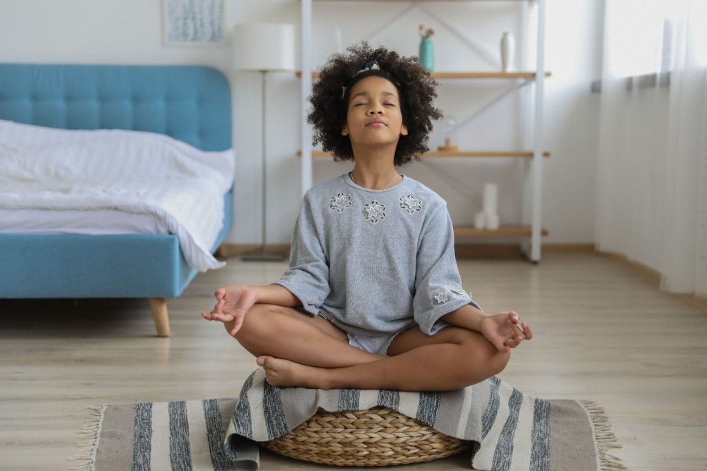 Girl meditating in her room