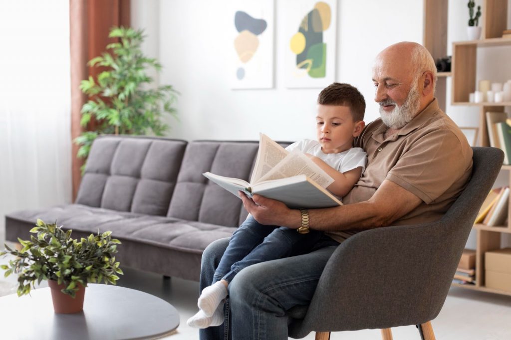 Child reading a book with grandfather