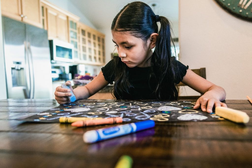 Little girl drawing on paper