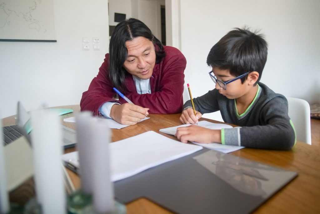 A Teacher Teaching a Boy