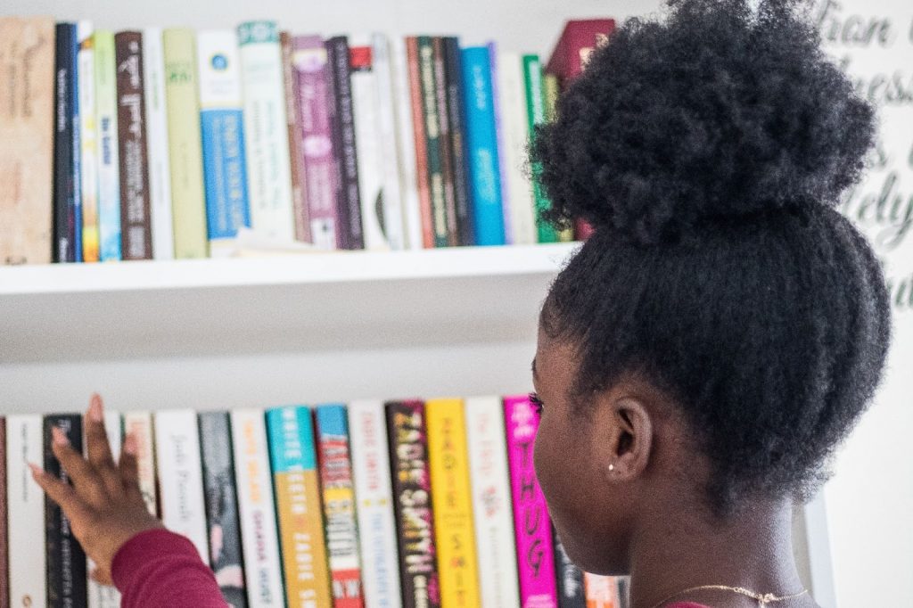 GIrl picking a book from a shelf