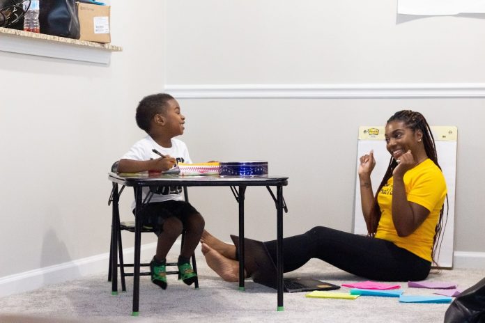 Mom teaching her son at home