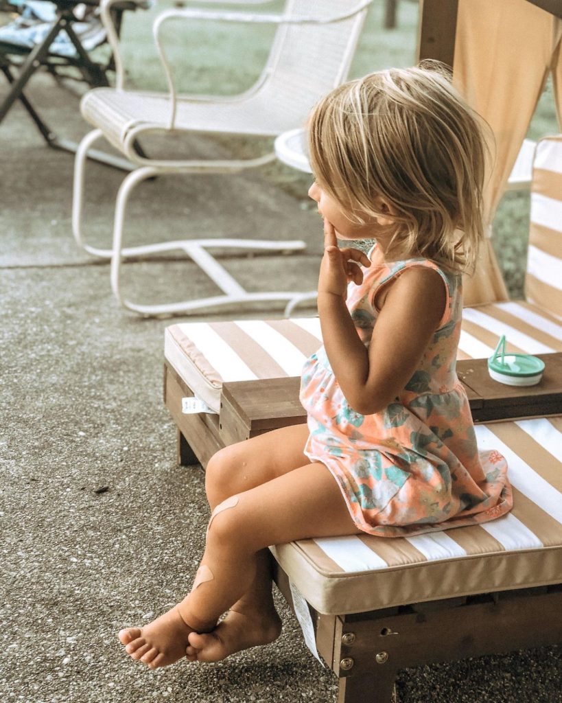 Little girl sitting on a chair thinking