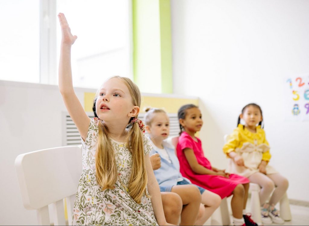 Kids sitting on chairs playing a game