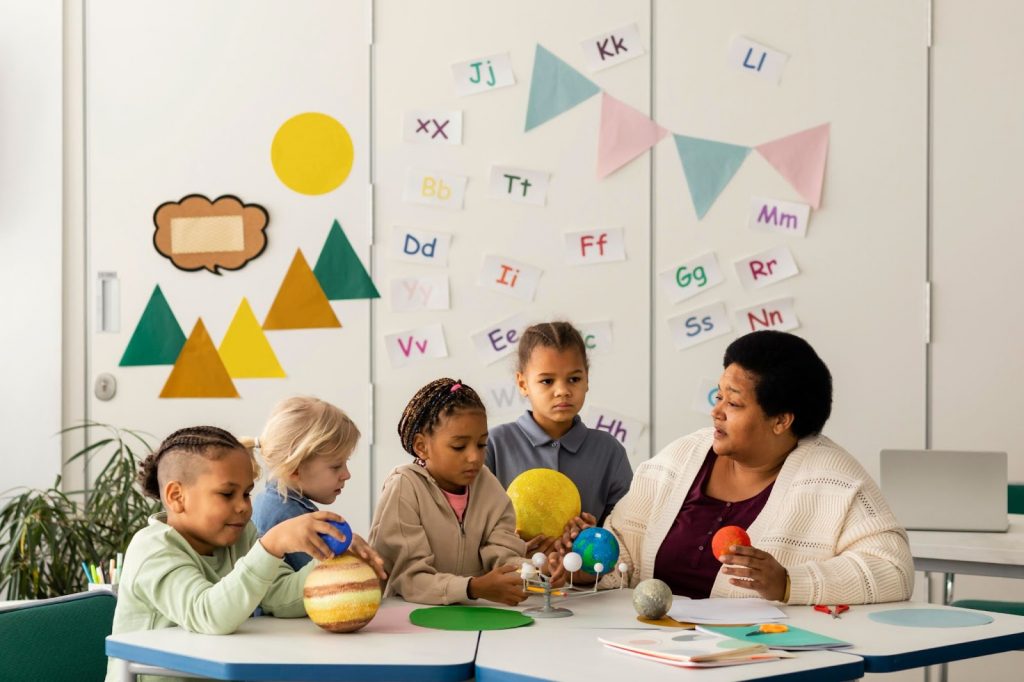 Teacher teaching kids about planet using tactile aids