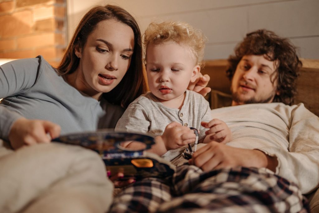 Mother reading a book to her child