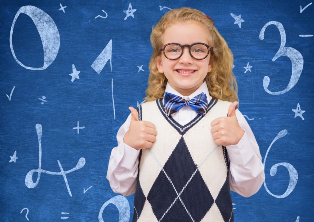 Kid dressed up in uniform standing infront of a math sign background