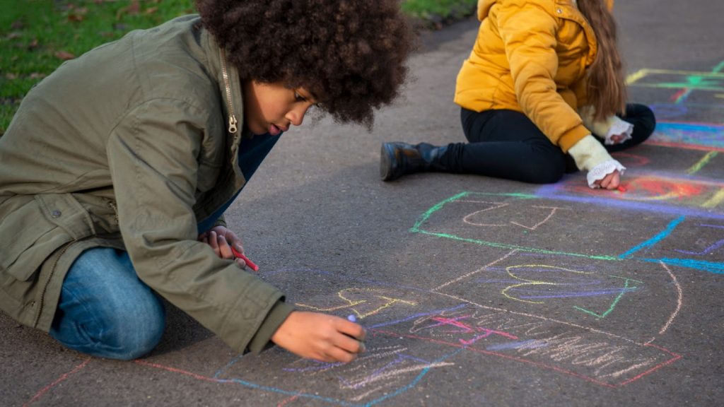 Kids drawing on the pavement