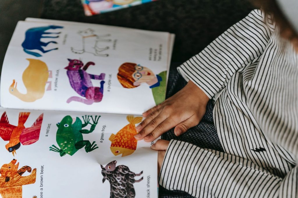 A kid looking at a picture book