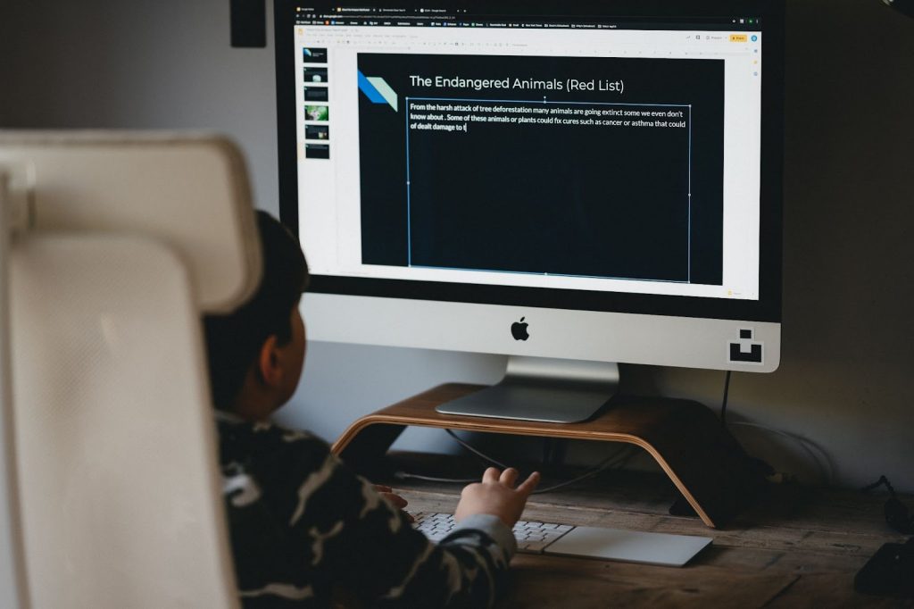 Kid creating a presentation on a computer