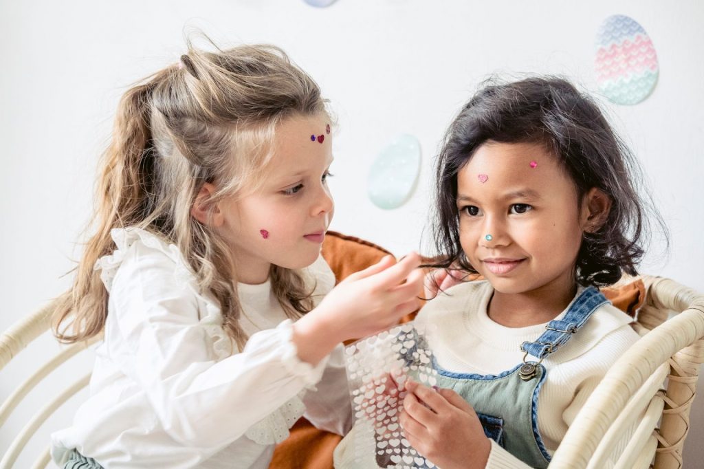 Two girls playing with stickers