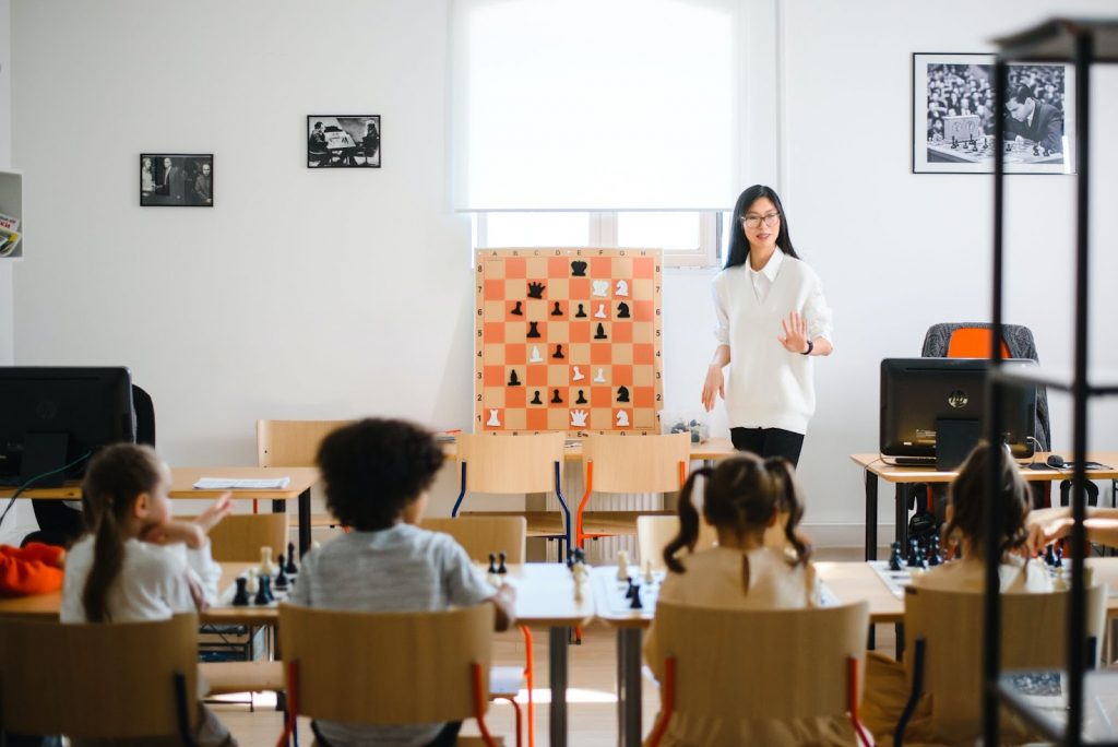 Teacher teaching in class using handmade charts