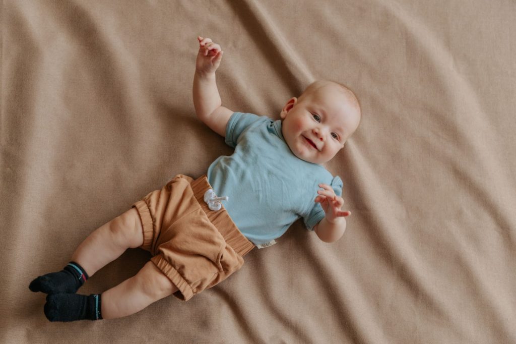 Infant lying on bed