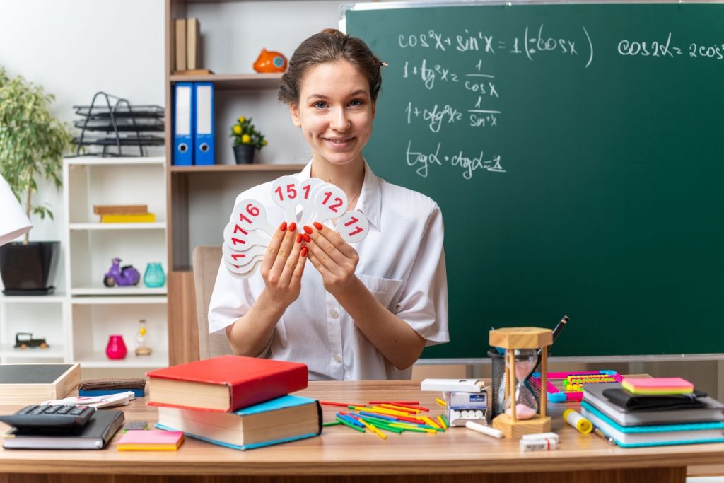 Teacher holding math flashcards